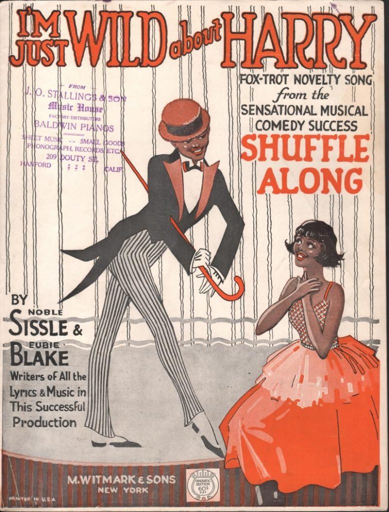 Cover page of printed sheet music for "I'm Just Wild About Harry". Features lithographed image of well-dressed black man with cane and tails standing next to a black woman in red gown, apparently kneeling. 
