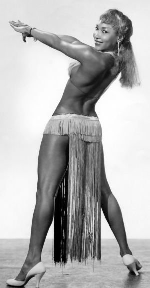 Lottie the Body poses in a panel skirt