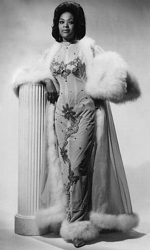 Miss Toni Elling poses in a gown and fur coat